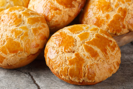 Homemade Chinese pineapple buns freshly baked and fluffy resemble the texture of pineapple close-up...