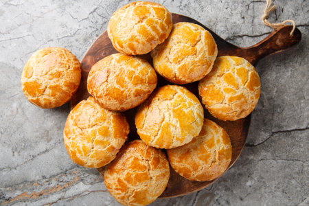 Homemade Chinese pineapple buns freshly baked and fluffy resemble the texture of pineapple close-up on the table. Horizontal top view from aboveの写真素材