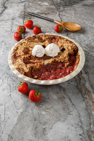 Summer delicious Chocolate strawberry cobbler with ice cream close-up in baking dish on table. Verticalの写真素材