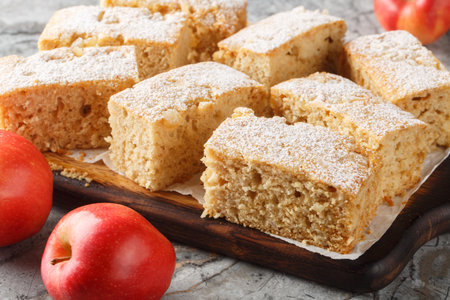 Delicious old fashioned applesauce cake with ginger and cinnamon close-up on wooden board on a table. horizontalの写真素材
