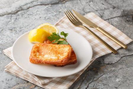 Saganaki is a very popular Greek appetizer of pan-seared cheese served alongside lemon wedges...