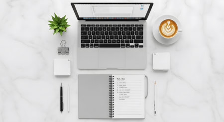 Laptop, notebook, coffee cup and stationery on white marble background. 3d rendering.の素材