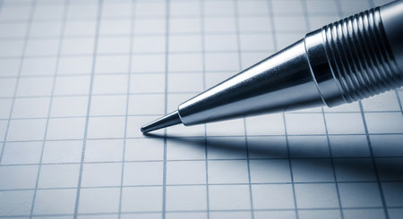 Closeup of a ballpoint pen on a checkered paperの素材