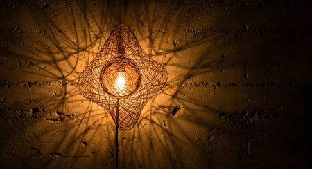 Close up of lamp hanging on the wall. Light and shadows.の素材