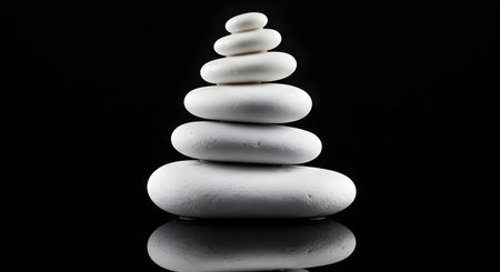 Pyramid of white zen stones on a black background. Zen conceptの素材