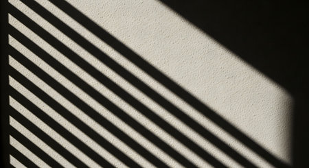 Shadow of blinds on a white wall. Selective focus.の素材