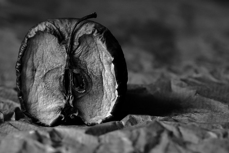 black and white photo of wrinkled apple halfの写真素材