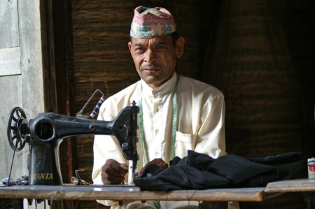 Kathmandu, Nepal, october 11, 2010: Taylor sews clothes with a sewing machineのeditorial素材