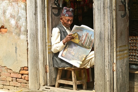 Kathmandu, Nepal - October 10, 2010: nepalese man who read the newspaperのeditorial素材