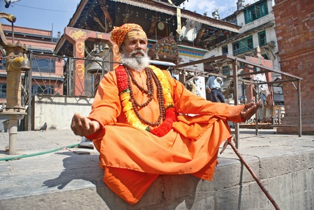 Kathmandu, Nepal - October 10, 2010: Shaiva sadhu (holy man) seeking alms in front of a templeのeditorial素材