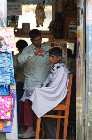 Kathmandu, Nepal - October 4, 2010: hairdresser cut the hair on the streetのeditorial素材