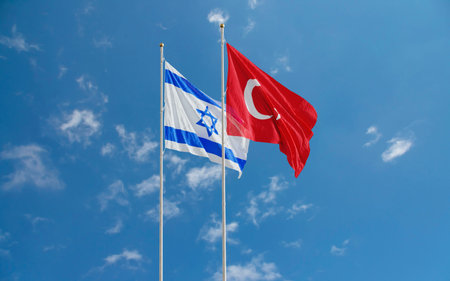 Israel and Turkey Flags waving against a blue sky background. Jerusalem â€“ Ankara diplomatic...