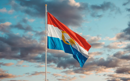 The flag of the Malaysian state of Labuan waving in the wind against a dawn sky close-up. National Labuan symbol and sign of the state with the capital Victoriaの写真素材
