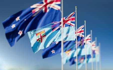 Waving flags of New Zealand and the Fiji Island. A symbol of political and economic relations between two countries. Partnership and competition in the world stage.の写真素材