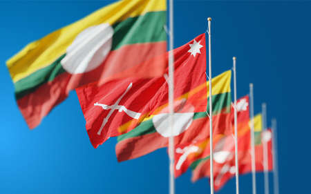 Waving flags of Shan State and Shan State Army South in Myanmar against blue sky background.の写真素材
