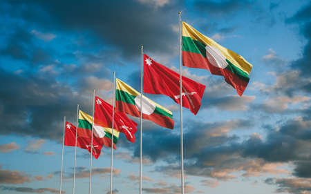 Waving flags of Shan State and Shan State Army South in Myanmar sunset sky background.の写真素材