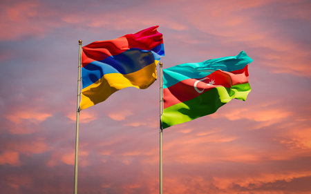 Armenia and Azerbaijan flags together waving in the sky background. Concept of relations between two...