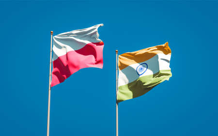 Beautiful national state flags of Poland and India together at the sky background. 3D artwork concept.の写真素材