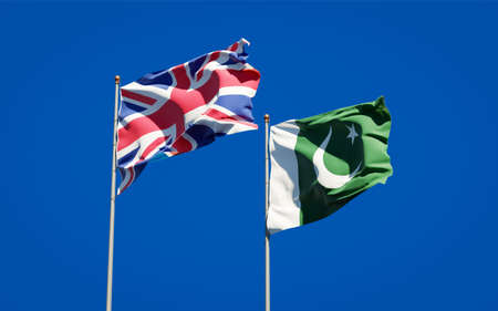 Beautiful national state flags of UK and Pakistan together at the sky background. 3D artwork concept.の写真素材