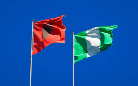 Beautiful national state flags of Nigeria and Albania together at the sky background. 3D artwork concept.の写真素材