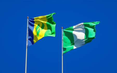 Beautiful national state flags of Saint Vincent and the Grenadines and Nigeria together at the sky...