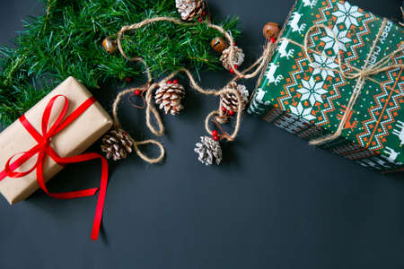 Christmas gifts surrounded by Christmas decorations. Snowflakes and leaves on a Christmas treeの写真素材