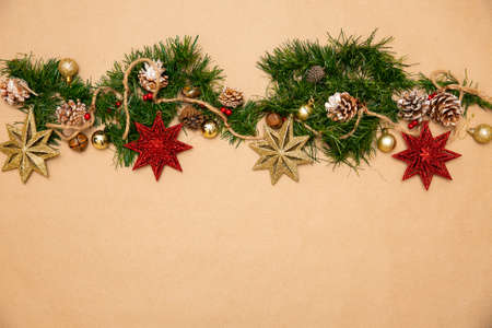 Christmas ornaments. Leaves of a christmas tree with red stars, golden spheres and snowflakesの写真素材