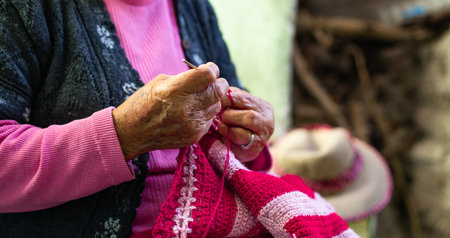 Old woman knitting at home in the evening.の写真素材