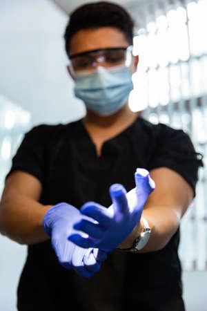 Doctor wearing blue latex gloves. Front viewの写真素材