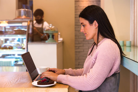 Beautiful Women Using Laptop In Coffee Shop