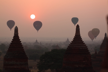 air balloons over Buddhist temples at sunrise. Bagan, Myanmarの写真素材
