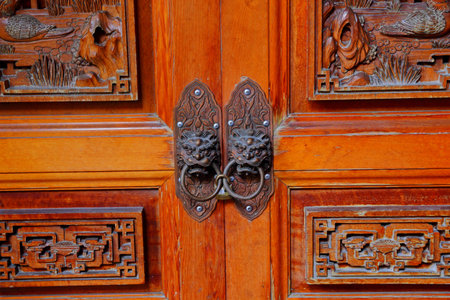 Traditional wooden gate with Lion door knockers at Qingshui Zushi Master Temple in new taipei city,...