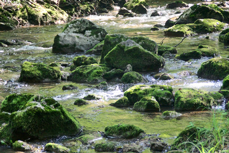 Stones and the water flow in the riverの写真素材