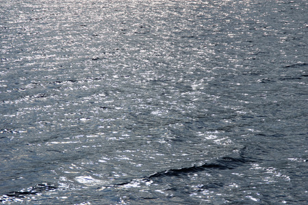 Bright sun glare on the waterの写真素材