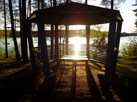 View of the lake and pavilion in the lakeside during sunsetの写真素材