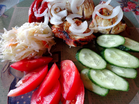 Grilled meat and vegetable garnish on the glass plateの写真素材