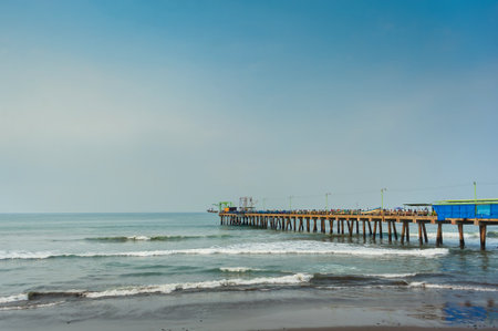Wide shot of the pier at Puerto de La Libertad in El Salvador, extending over the Pacific Ocean on a clear day.の写真素材