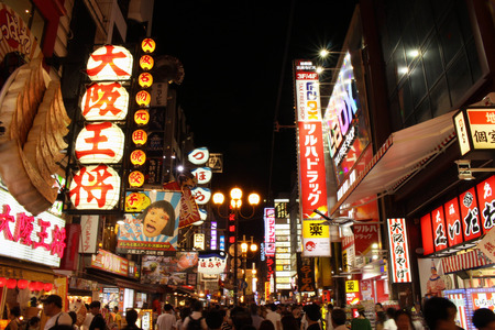 the crowded and bright Osaka at night. People, which are locals and tourists, flocked around the shopping area in Osaka. Not far from the famous icon "glico" (or "Guriko" as the locals say). Pic was taken in Japan, August 2017.のeditorial素材