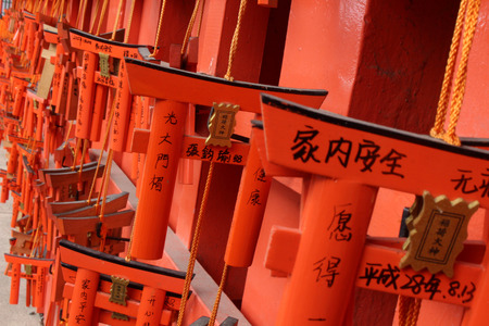 The prayer plaques (called "Ema" in Japanese) at Fushimi Inari Shrine in Kyoto, Japan. It looks like a mini gate of a Shinto Shrine. Pic was taken in Japan, August 2017.のeditorial素材