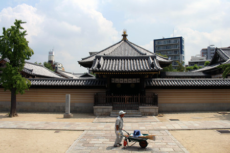 A worker walking in front of Japanese shrine's gate. Pic was taken in Osaka, Japan (August 2017).のeditorial素材