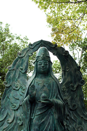 A statue of syncretism (?). It looks like Guanyin (or Kanon in Japanese), but it holds a cross as what Saint Mary usually does in her pose. Pic was taken in Japan, August 2017.のeditorial素材