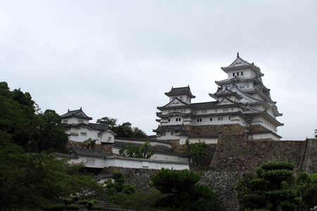 Walking closer to Himeji Castle (that's also called "White Heron") located on a hilltop on a cloudy day.のeditorial素材