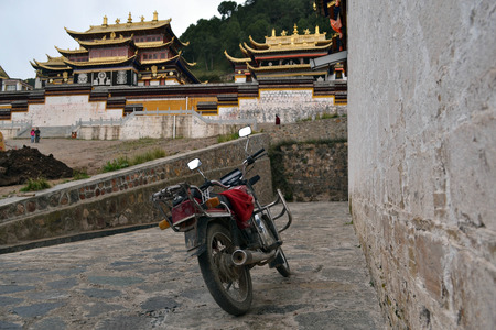 A motorcycle parked in front of Serti Gompa Monastery in Langmusi, Amdo Tibet. Pic was taken in September 2017.の写真素材
