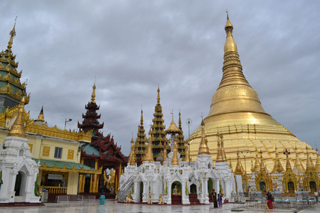 The national religious symbol of Burmese. It's the shwedagon Pagoda with its golden stupa, and many people visiting this place. Pic was taken in Yangon, Burma - August 2015.のeditorial素材