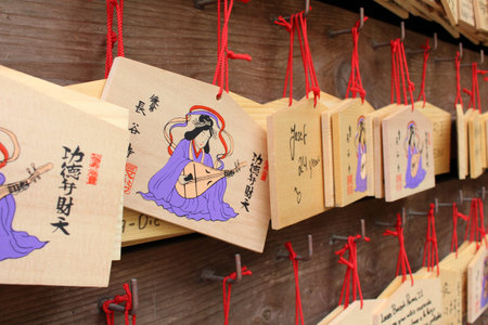 Translation: The wooden-plate prayer (ema) used in Japanese Shinto ritual at Hasedera Temple. Taken...