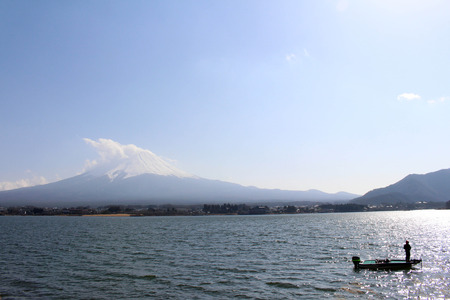 Mount Fuji as seen from Lake Kawaguchi. People are doing sport and taking photos, meanwhile. Taken in Yamanashi, Japan - February 2018.の写真素材