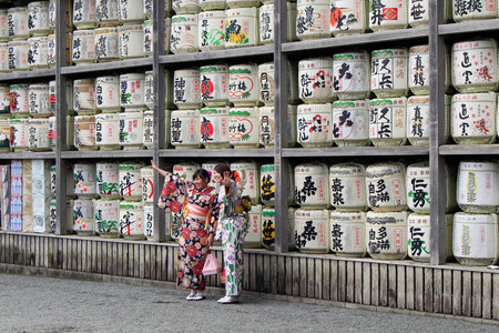 Girls in kimono in front of drums or barrels of sake (Japanese alcoholic drinks) at Tsurugaoka shrine. Taken in Kamakura, February 2018.のeditorial素材