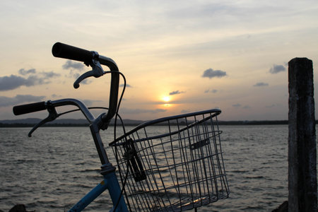 A bicycle and sunset around Bendiwewa Lake in Polonnaruwa. Taken in Sri Lanka, August 2018.の写真素材