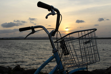 A bicycle and sunset around Bendiwewa Lake in Polonnaruwa. Taken in Sri Lanka, August 2018.のeditorial素材