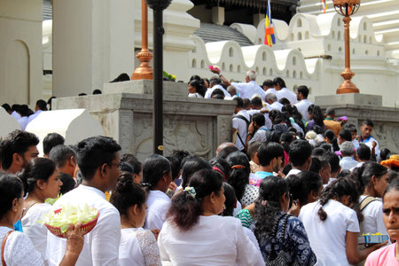 Pilgrims entering and praying at the Temple of the Sacred Tooth in Kandy. Taken in Sri Lanka, August...